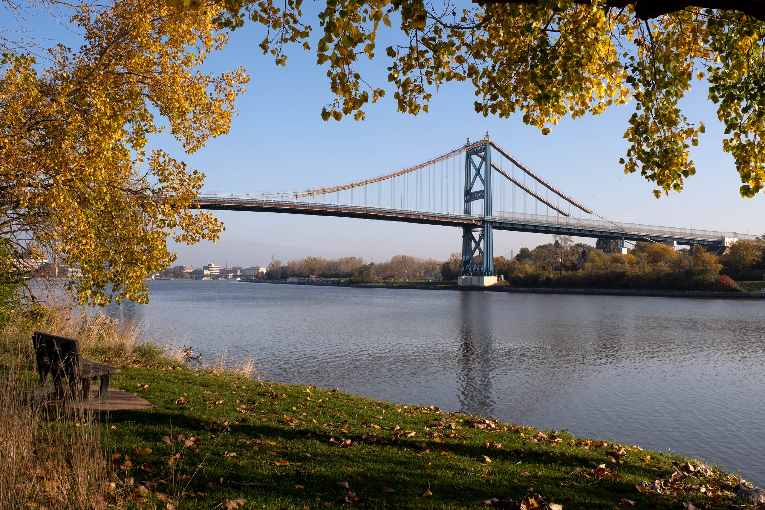 Blue bridge over river in autumn