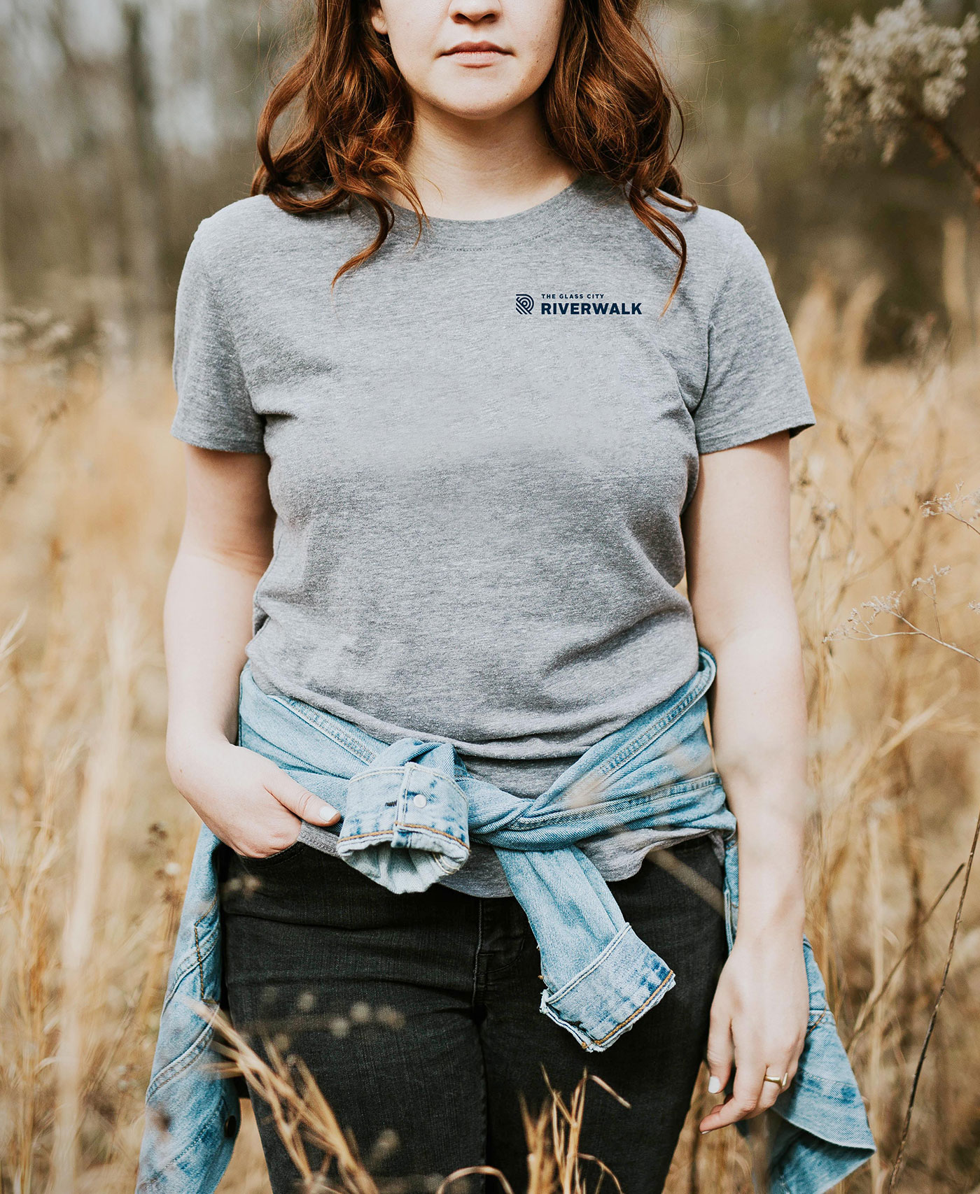 Woman wearing gray t-shirt with Glass City Riverwalk logo